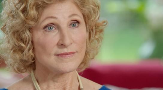 Close-up of Beth, speaking to camera, inside her house.