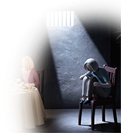 Woman in restaurant, sitting in a chair but apart from others at the table. A single light shines through a barred window, casting her in a grim spotlight.